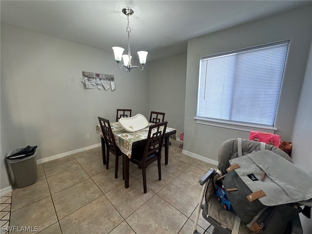 tiled dining area featuring a notable chandelier