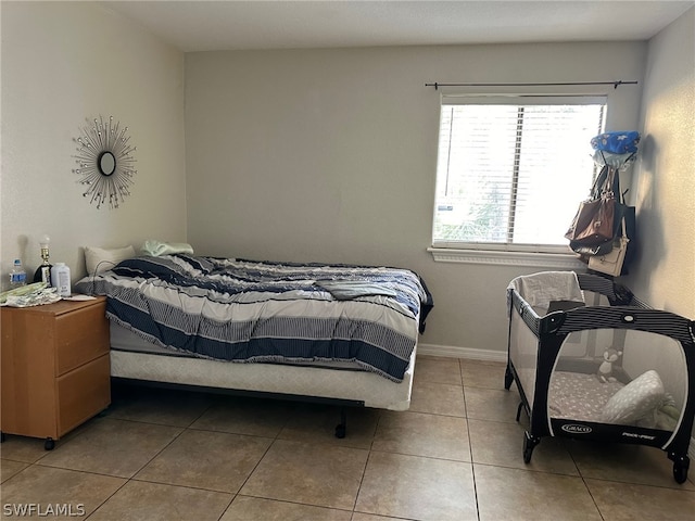 bedroom featuring multiple windows and tile floors