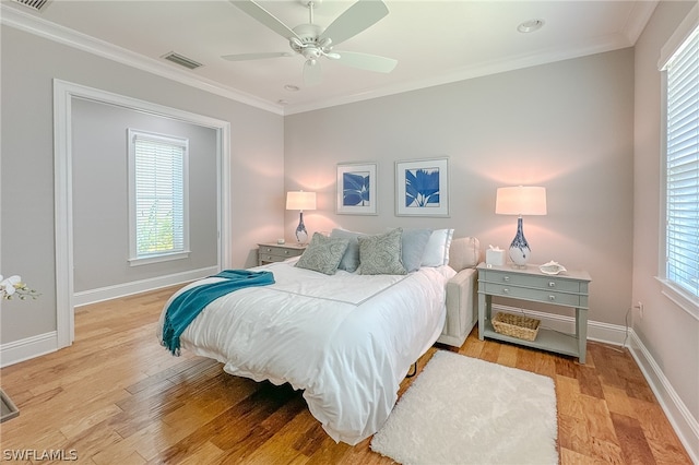 bedroom with ornamental molding, ceiling fan, and light wood-type flooring