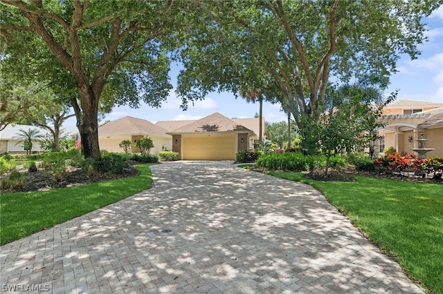 view of front of property with a garage and a front yard