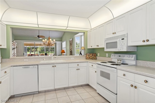 kitchen featuring a wealth of natural light, white cabinets, white appliances, and sink