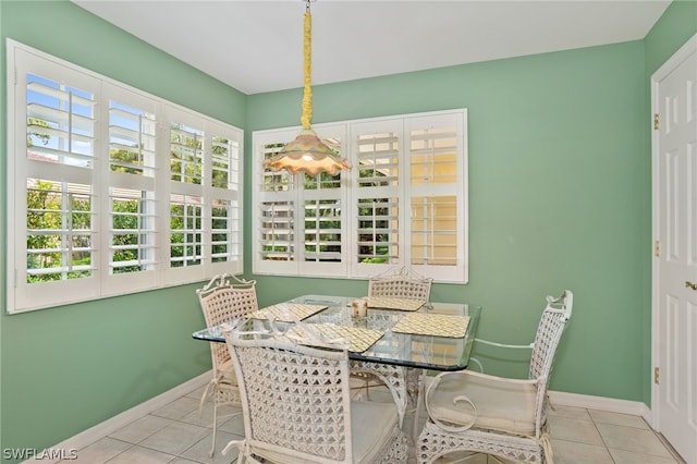 dining space with light tile flooring