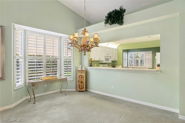 unfurnished dining area with a healthy amount of sunlight, a notable chandelier, and light carpet