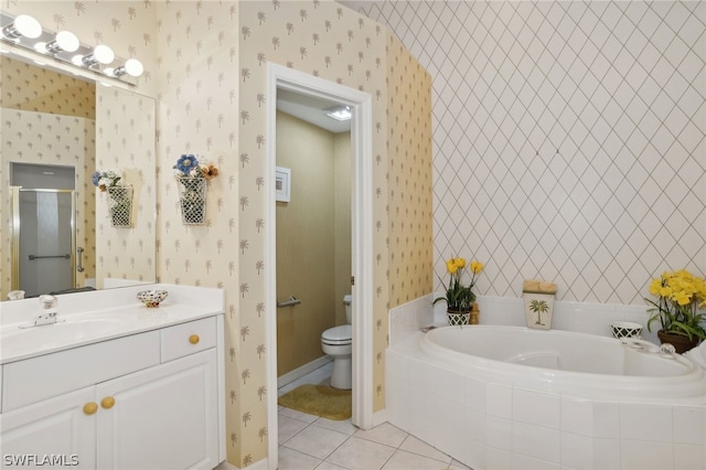 bathroom featuring tiled tub, toilet, tile floors, and vanity