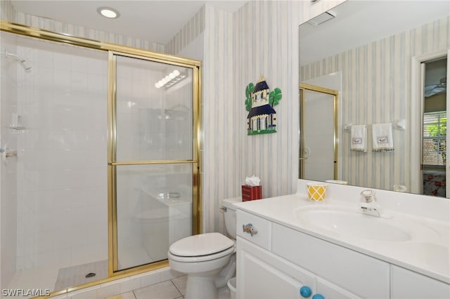 bathroom with tile flooring, vanity with extensive cabinet space, an enclosed shower, and toilet