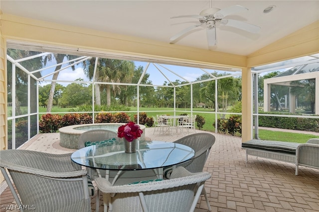 sunroom featuring ceiling fan and vaulted ceiling