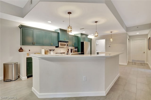 kitchen featuring decorative light fixtures, stainless steel appliances, a kitchen island with sink, green cabinets, and light tile floors