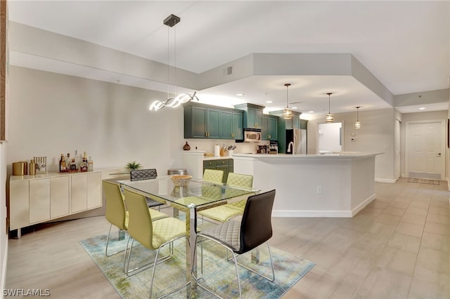 dining area with sink and light hardwood / wood-style floors