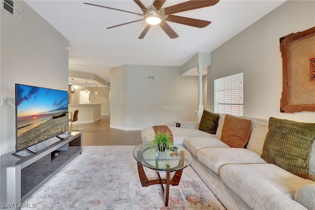 tiled living room with ceiling fan