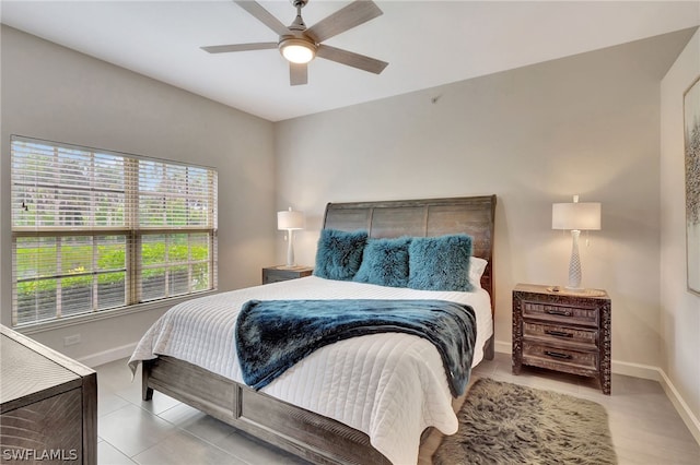 tiled bedroom featuring ceiling fan