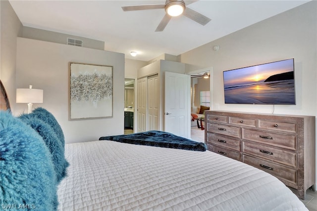 bedroom featuring tile floors, connected bathroom, a closet, and ceiling fan