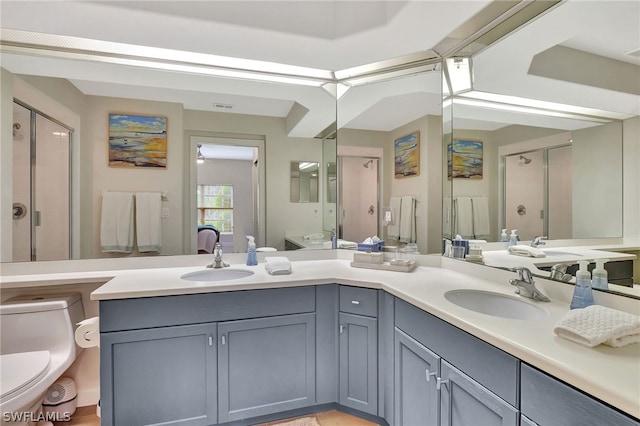 bathroom featuring dual bowl vanity and toilet