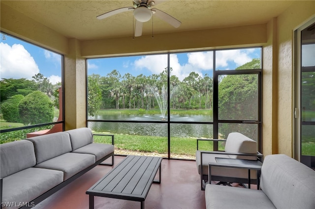 sunroom / solarium with ceiling fan and a water view