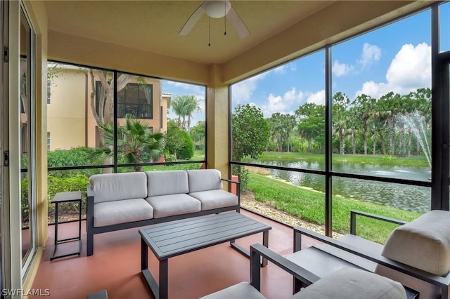 sunroom / solarium with a water view and ceiling fan