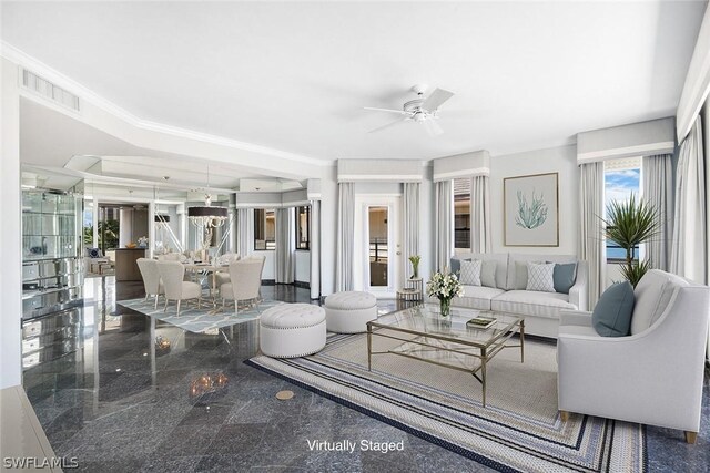 living room featuring ceiling fan, crown molding, and tile patterned floors