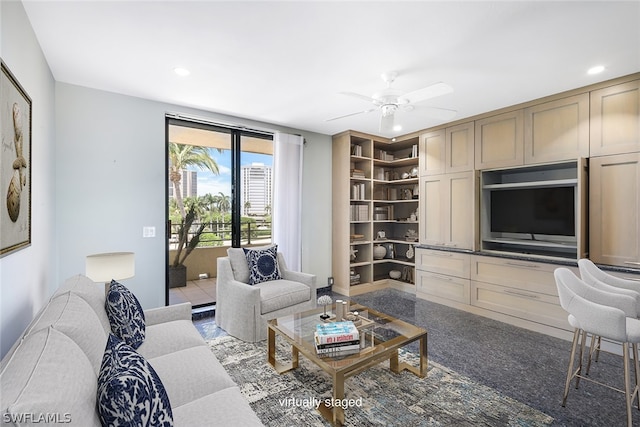 carpeted living room featuring ceiling fan