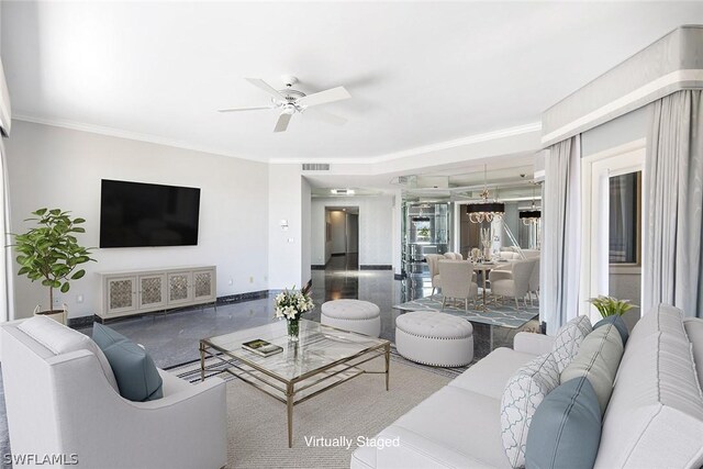 tiled living room with ceiling fan and crown molding