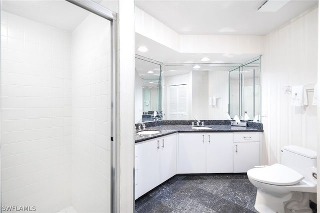 bathroom with walk in shower, tile patterned floors, vanity, and toilet