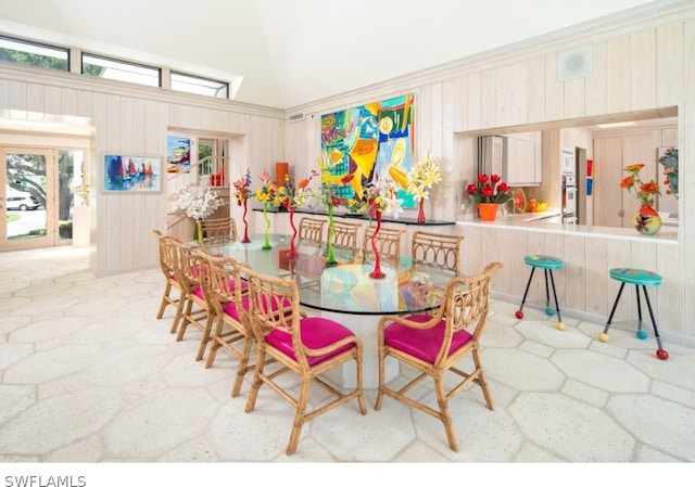 dining area with sink, a towering ceiling, and ornamental molding