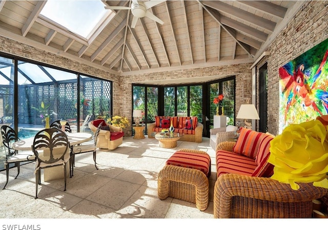 sunroom / solarium featuring wood ceiling, lofted ceiling with skylight, and ceiling fan