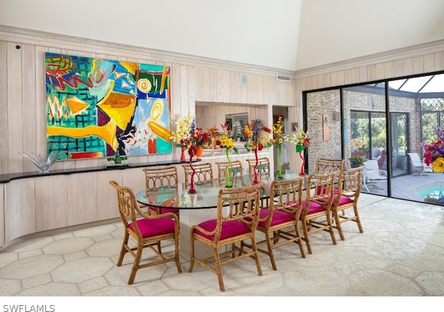 dining area featuring high vaulted ceiling