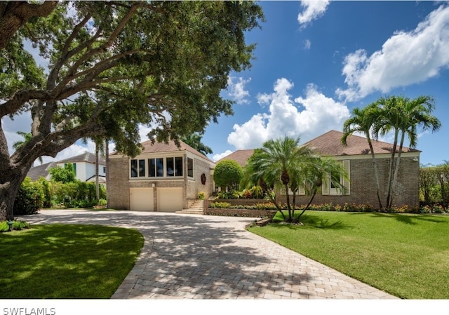 mediterranean / spanish-style home with a garage and a front yard