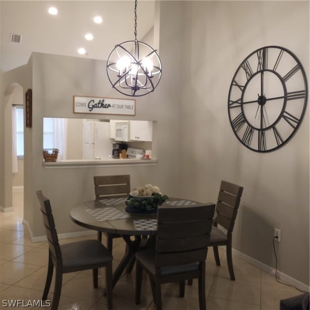 dining room featuring a chandelier and light tile floors