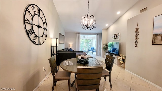 dining space featuring light tile floors and an inviting chandelier