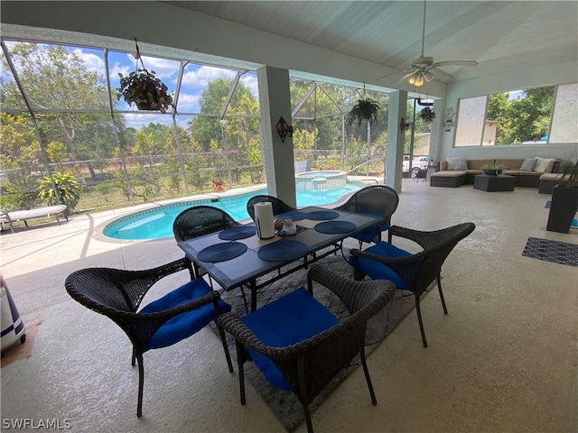 view of patio / terrace with outdoor lounge area, ceiling fan, and glass enclosure