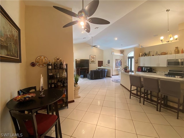 interior space featuring vaulted ceiling and ceiling fan with notable chandelier