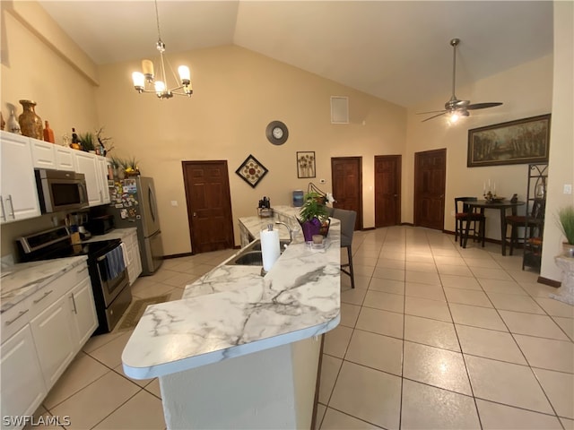 kitchen with decorative light fixtures, white cabinets, high vaulted ceiling, stainless steel appliances, and sink