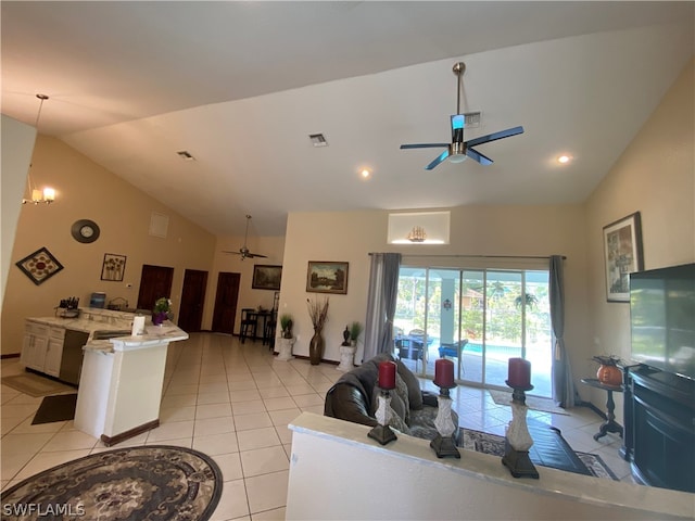 tiled living room featuring high vaulted ceiling and ceiling fan