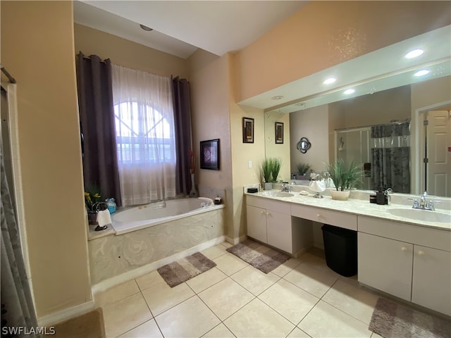 bathroom with a tub, large vanity, tile floors, and double sink