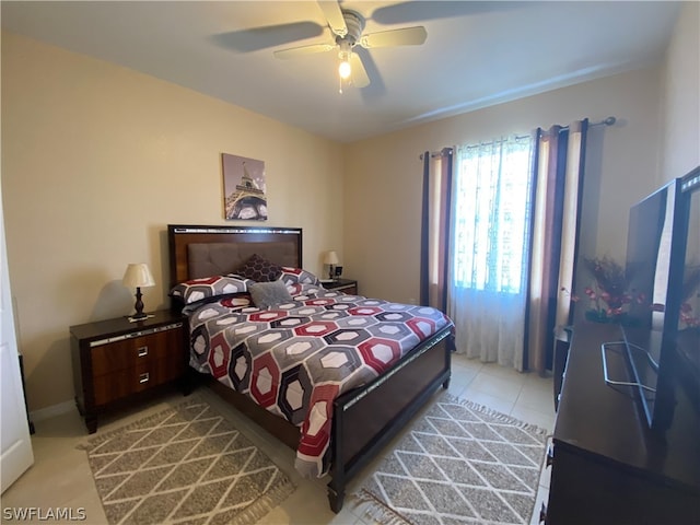 tiled bedroom featuring ceiling fan