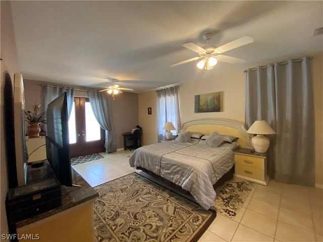 tiled bedroom featuring ceiling fan