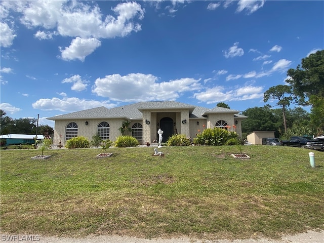 mediterranean / spanish home featuring a front lawn