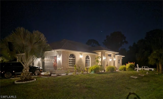 mediterranean / spanish house with a lawn