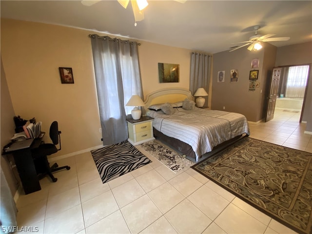 tiled bedroom featuring ceiling fan and connected bathroom