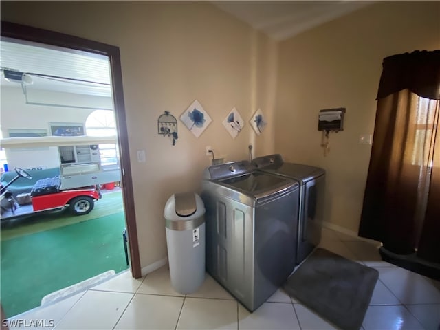 clothes washing area featuring hookup for a washing machine, light tile flooring, and washing machine and clothes dryer