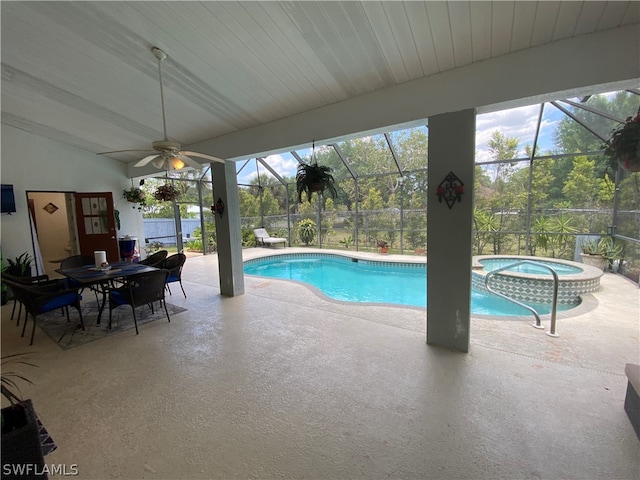 view of swimming pool with a patio, ceiling fan, an in ground hot tub, and glass enclosure