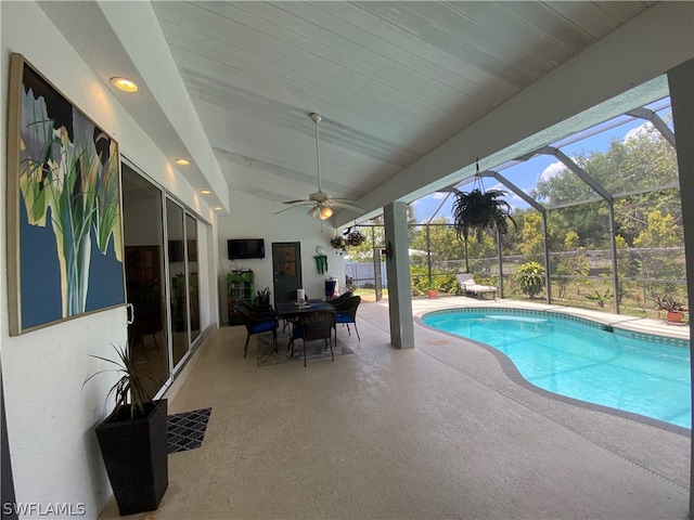 view of pool featuring a patio area, ceiling fan, and a lanai