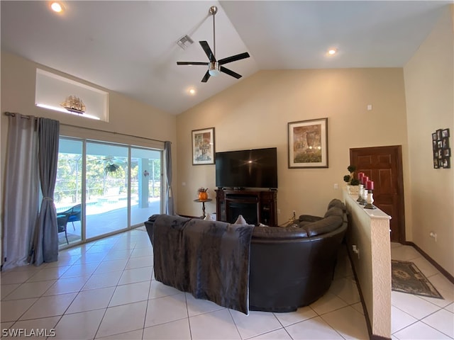 living room featuring lofted ceiling, ceiling fan, and light tile floors