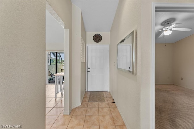 tiled entryway with ceiling fan