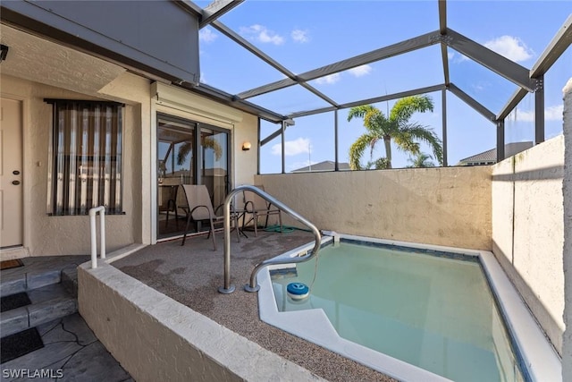 view of swimming pool with a lanai and a patio area