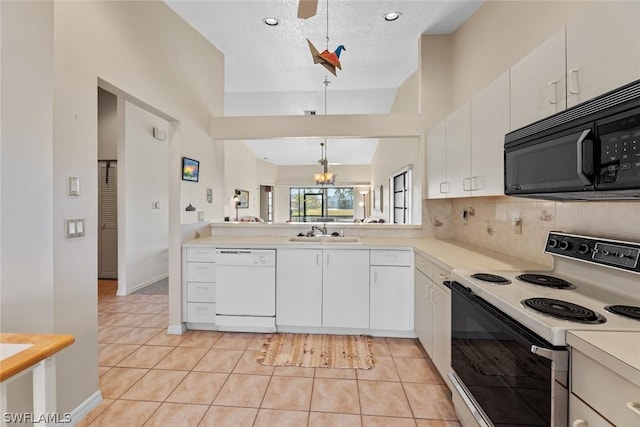 kitchen featuring white cabinetry, light tile patterned floors, hanging light fixtures, and white appliances