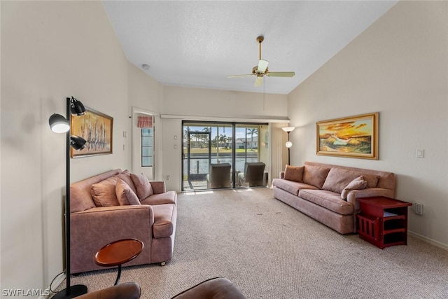 living room with ceiling fan, high vaulted ceiling, and light colored carpet