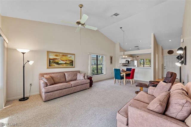 carpeted living room featuring high vaulted ceiling and ceiling fan