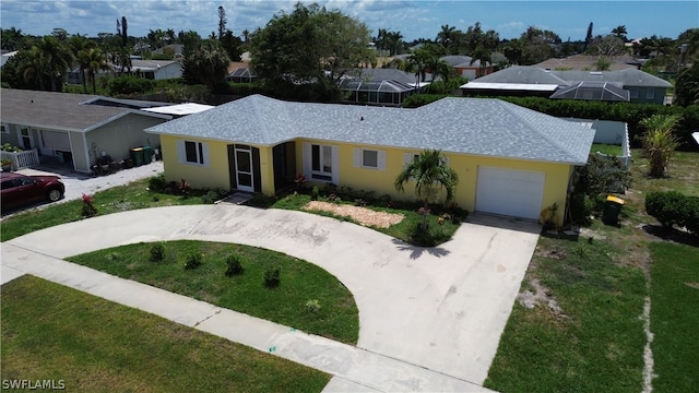 single story home featuring a garage and a front yard