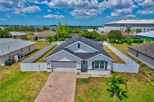 view of front of house featuring a garage and a front yard