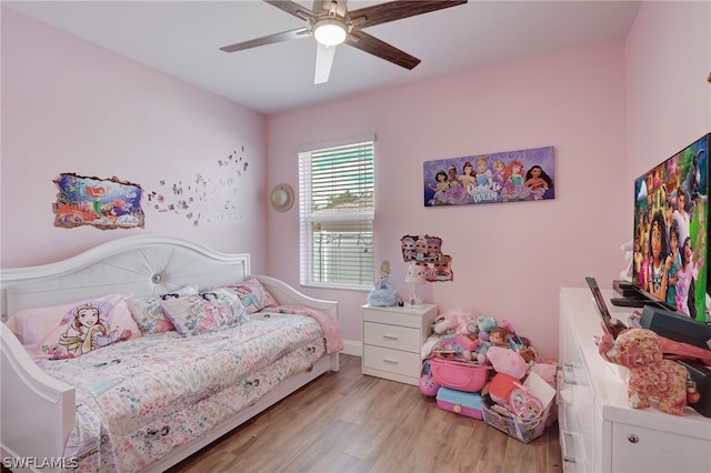 bedroom with light hardwood / wood-style floors and ceiling fan